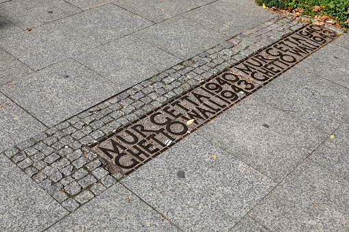 Warsaw, Poland - September 1, 2023: Marked on the pavement is the location of the Warsaw Ghetto Wall, the largest German-built ghetto in Nazi-occupied Europe during World War II.