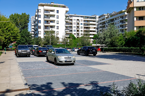 Warsaw, Poland - August 20, 2023: A small car park for residents of nearby blocks of flats in the Goclaw housing estate in the Praga-Poludnie district.