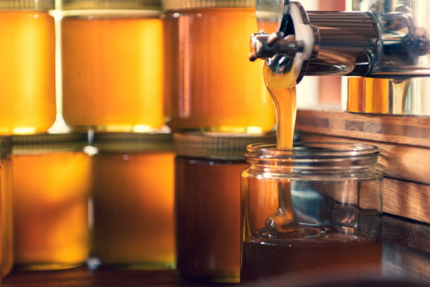 istock The fresh honey flows into a honey jar 1715070036