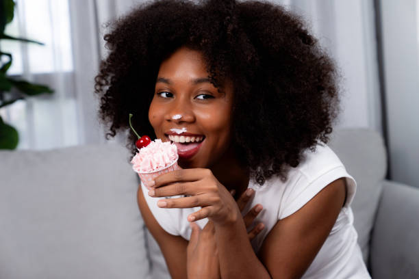 istock Funny African on mess face presenting cupcake in concept special. Tastemaker. 1715072382