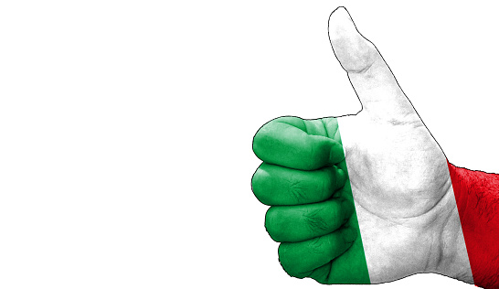 hand with thumbs up in approval with the Italian flag painted. Image with empty white background copy space area