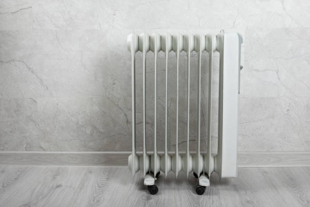 istock Different types of radiators. Heating systems store.Modern radiator at home. Central heating system. radiator, White radiator in the apartment.Expensive heating costs concept, close-up.Heating season. 1715091555