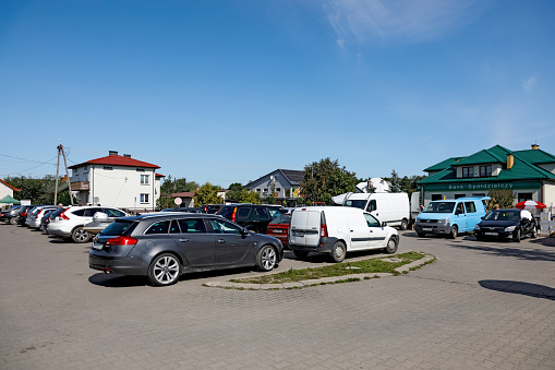 Wilga, Poland  August 12, 2023: There are a lot of cars in a car park in a village in the Mazowieckie Voivodeship, in the district of Garwolin. The origins of this town date back to the 13th century.