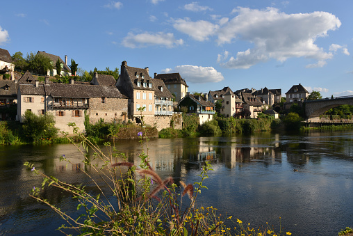 little idyllic town of Argentat-sur-Dordogne with Dordogne River and reflections in quiet water