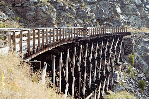 Senior woman friends on an observation deck off a trestle in Myra Canyon