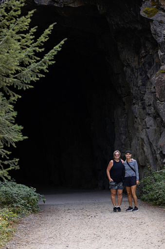 Two senior woman friends in front of a tunnel entrance