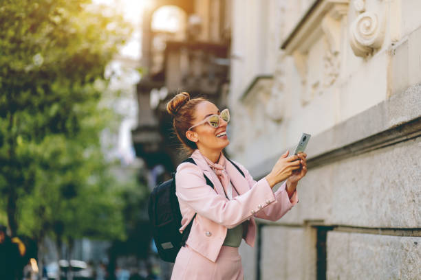 Elegant beautiful woman standing with smart phone Elegant beautiful woman standing with smart phone victoria house stock pictures, royalty-free photos & images