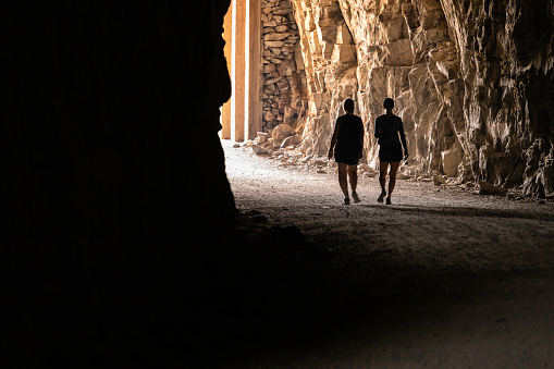 Two senior woman walking through tunnel at Myra Canyon