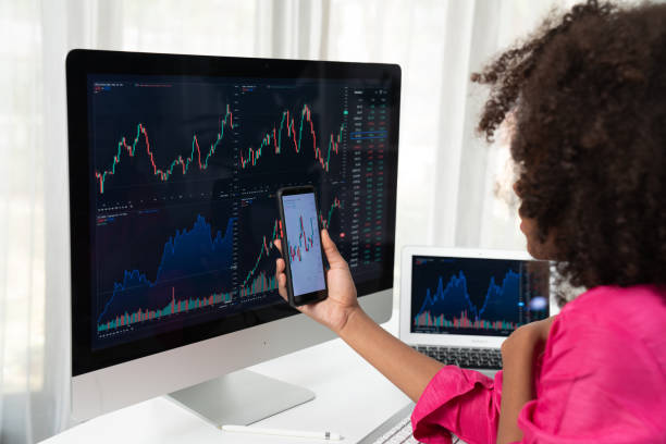 istock African woman blogger looking on computer screen and smartphone. Tastemaker. 1715146780
