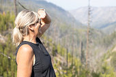 Female hiker looking into the distant valley at Myra Canyon