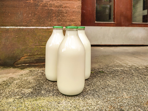 Bottled daily milk at door front in glasgow scotland england UK