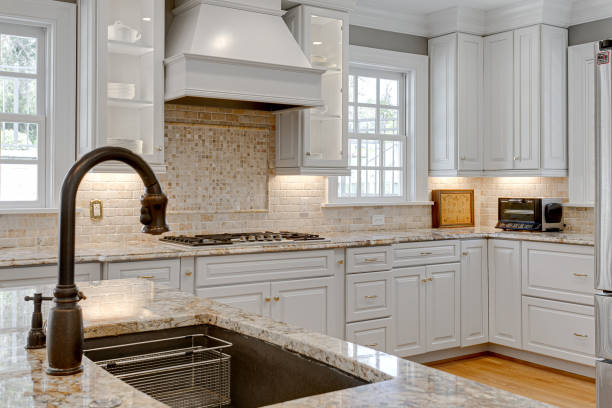 istock Large Sink with Faucet and Luxury Kitchen Interior with Stone Backsplash in Background 1715163442