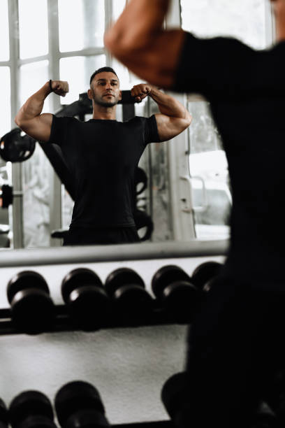 istock Male Bodybuilder Happy With Muscle Mass Progress 1715164010