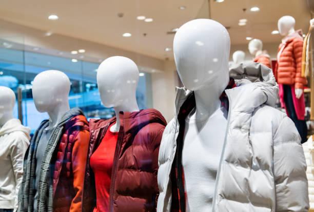 Baby mannequin in bright clothes in store close up