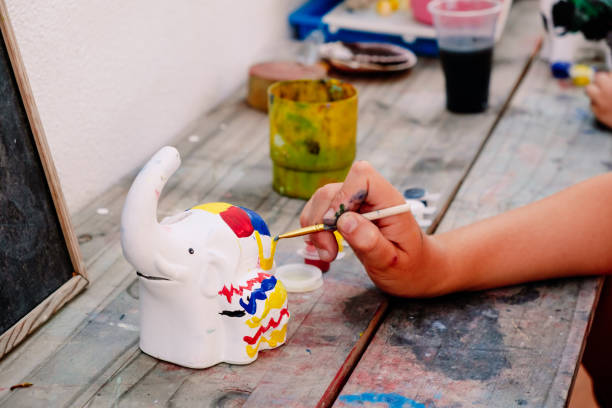 istock Child plays to unleash his creativity by decorating a white plaster figure with colored paints, during the summer holidays. 1715176699