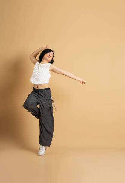 istock Image of Asian dancer dancing on beige background 1715177217