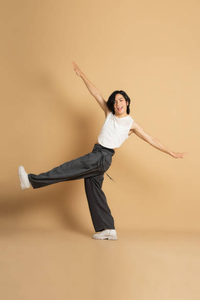 istock Image of Asian dancer dancing on beige background 1715177219