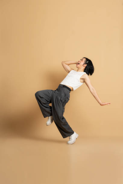 istock Image of Asian dancer dancing on beige background 1715177261