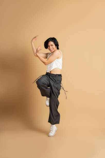 istock Image of Asian dancer dancing on beige background 1715177281