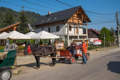 Gura Humorului, Romania - September 10, 2023: Peasants with horse carts at the Voronet market