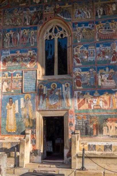 entrance and painted walls of the voronet monastery church, romania - voronet imagens e fotografias de stock