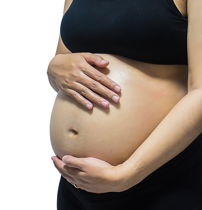 Close-up pregnant woman touching her belly. isolated on white background.