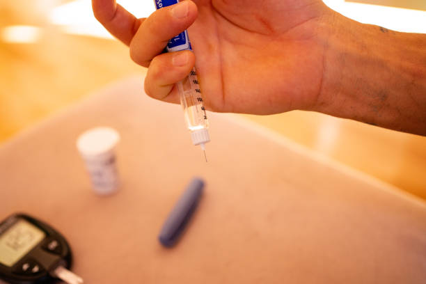 istock Male hand holding insulin shot 1715213931