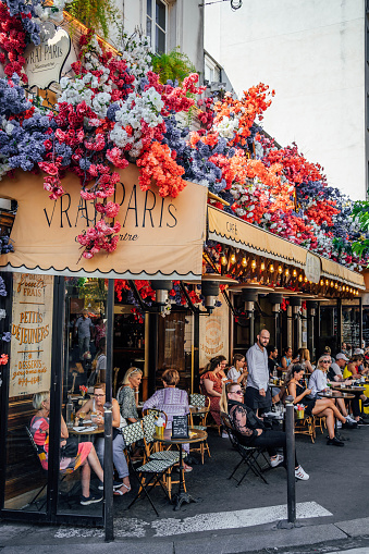 Paris, France - September 10, 2023: Beautiful floral café with tables outside in Paris, France.