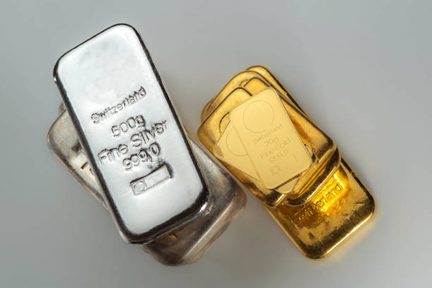 istock Gold and silver bars of various weights on a grey background. 1715216428