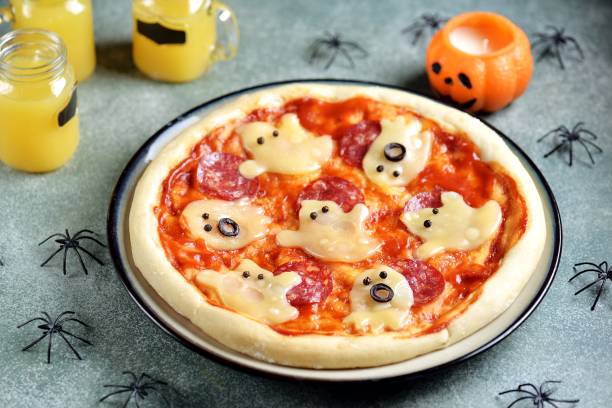 istock Homemade Halloween pizza with cheese ghost and salami 1715228295