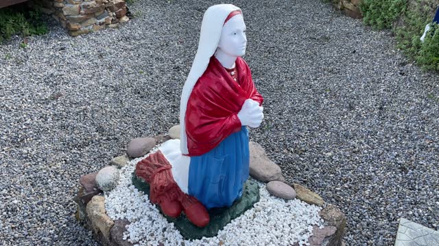 Statue of girl praying in the little village of Killea Waterford Ireland on a summer Day