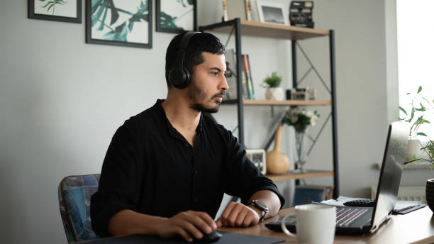 istock Handsome entrepreneur man working with laptop at home office 1715236215