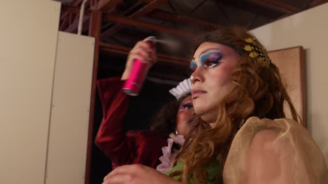 Drag queens getting dressed backstage before performance at theater