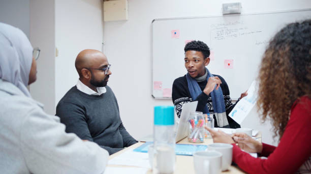 istock Young businessman explaining data on paper during an office meeting with colleagues 1715263122