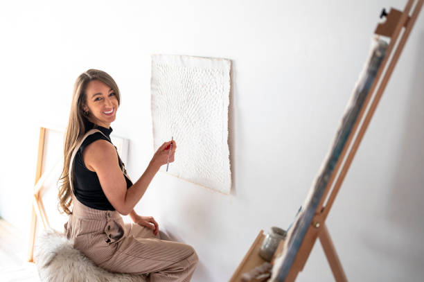 istock Female artist painting in studio 1715269471