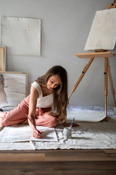 istock Female artist painting in studio 1715269472