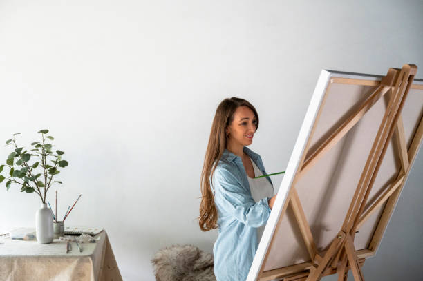 istock Female artist painting in studio 1715269477