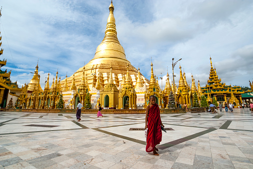 Burmese people walk around the Shwedagon Pagoda a golden Pagoda in Yangon, Rangoon, Myanmar, Asia, 8th of July 2009