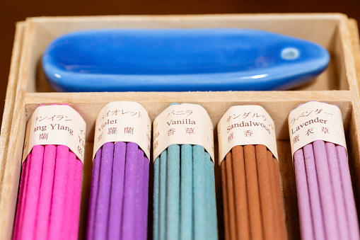 Multicolored, scented incense sticks in wooden box
