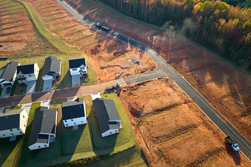 Aerial view of construction site with new tightly packed homes in South Carolina. Family houses as example of real estate development in american suburbs.