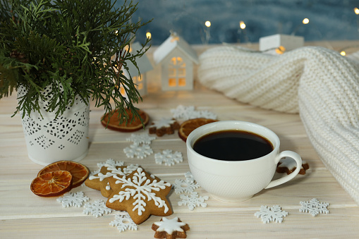 White cup of coffee with Christmas decorations. White and silver colours