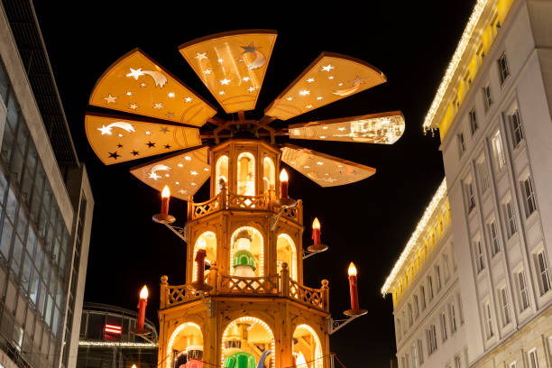 beautiful traditional german christmas market square in magdeburg city center germany with christmas pyramide many carousel, tree lights and decoration. christmas and new year celebration season - frankfurt german culture night city imagens e fotografias de stock