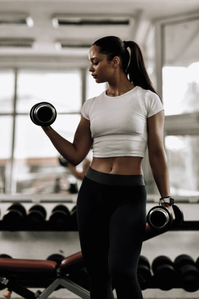 istock Athletic Female Taking Bicep Curl Form Nice And Slow 1715299282