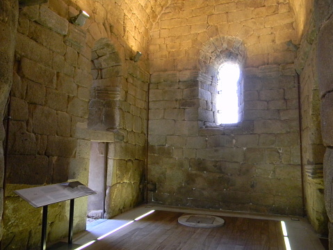 Sunlight enters the dark room through a barred window. View inside the tower of the Anakopia fortress.