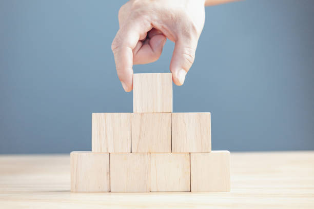 istock hand of a businessman stacking wood empty eight blocks with copy space for text or symbols, development concept for growth success process. 1715311446