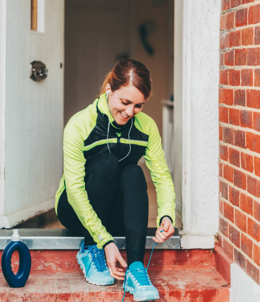Woman lacing running shoes before jogging