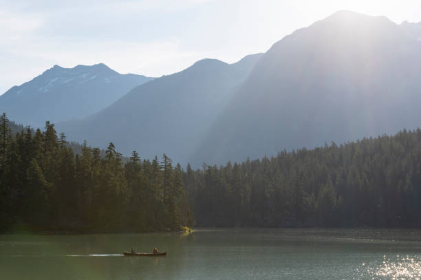 istock Family canoeing on a stunning mountain lake 1715326329