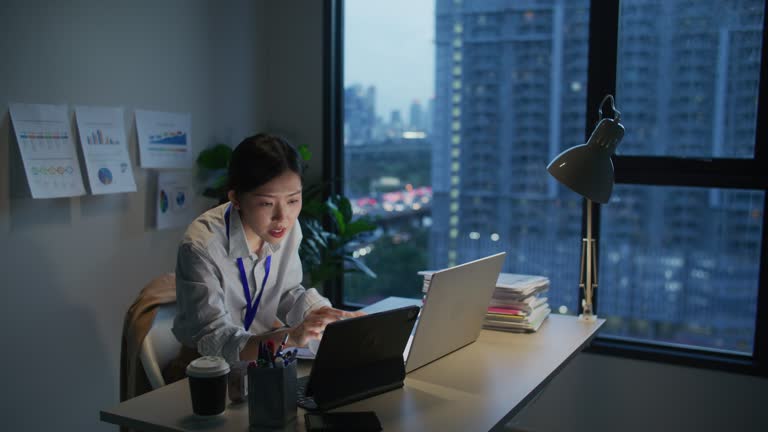 Asian businesswoman working late in office