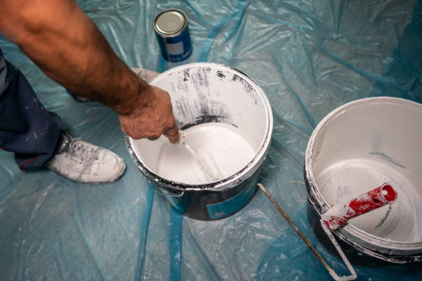 istock blue collar worker is mixing paint on floor horizontal construction still 1715336395