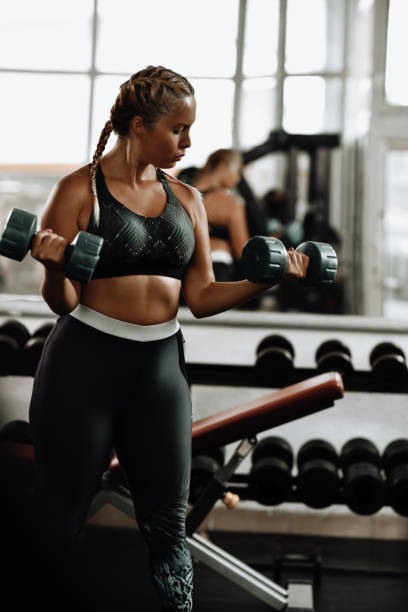 istock Female Athlete Optimizing Mind To Muscle Connection While Working On Bicep Curls In Gym 1715340227